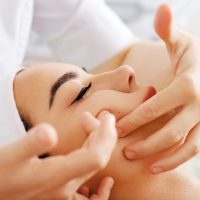 Beautiful woman having spa facial massage in beauty salon Beautiful woman having spa facial massage in beauty salon